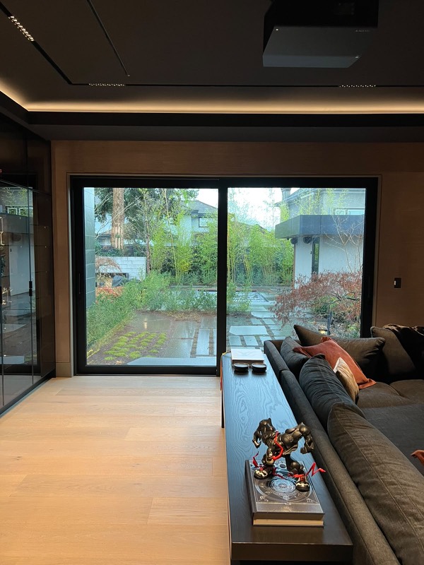 Black-framed sliding door in a media room after sealing