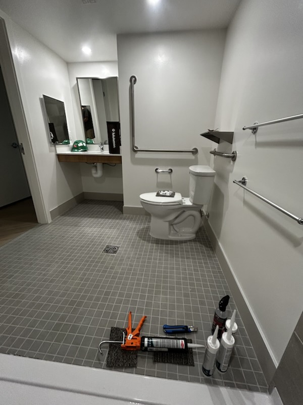 Accessible bathroom with silicone work in progress