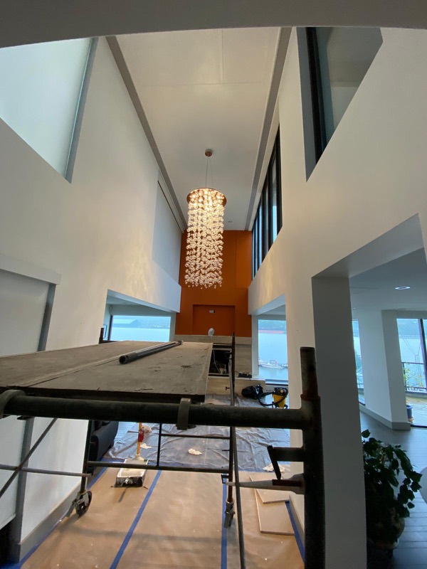 Two-storey foyer with chandelier during repairs