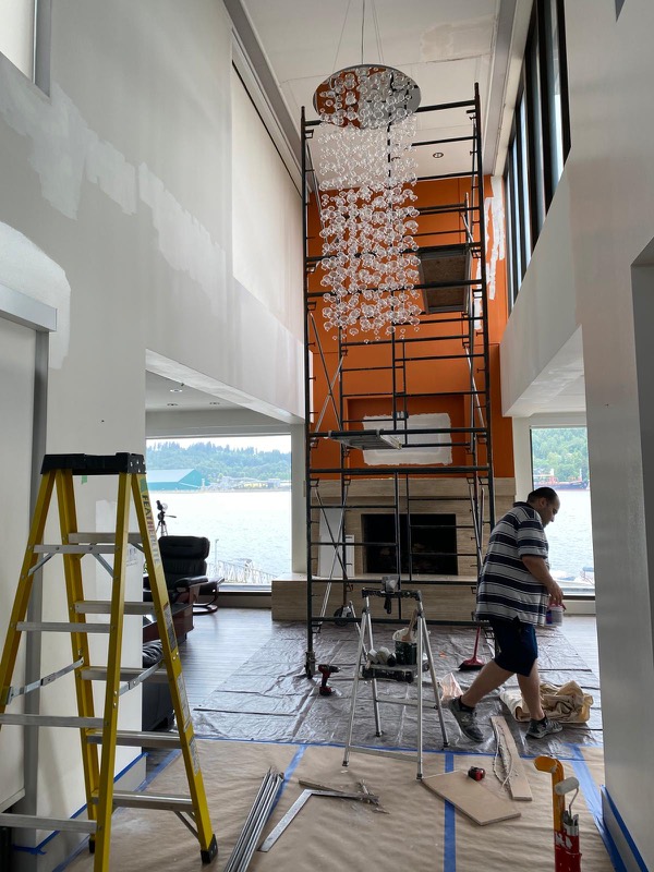 Nubrix crew painting a double-height foyer from scaffolding