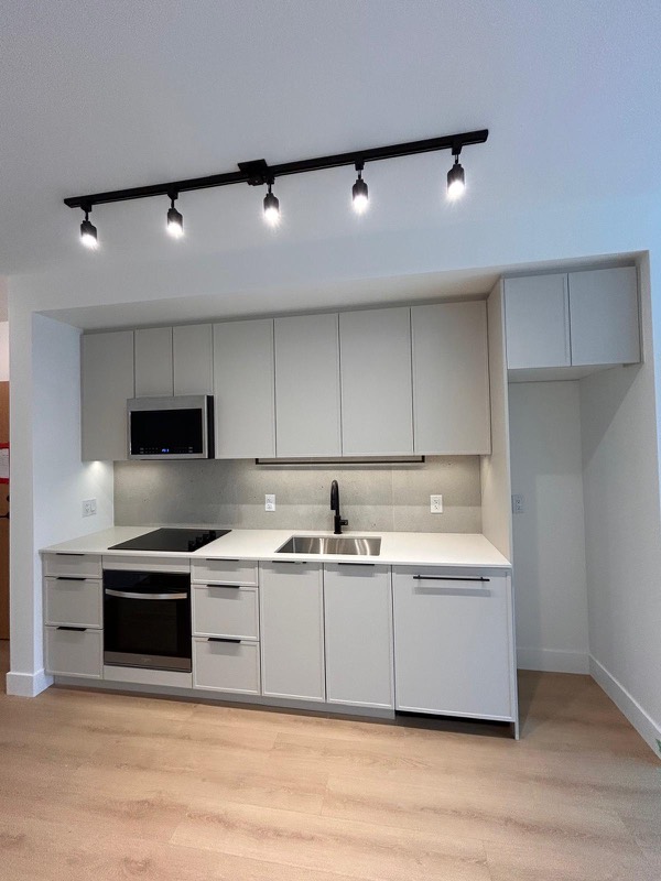 White condo kitchen with integrated appliances