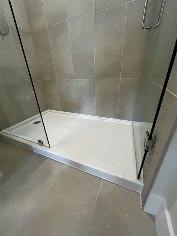 Shower base and glass enclosure sealed by Nubrix at The Merchant